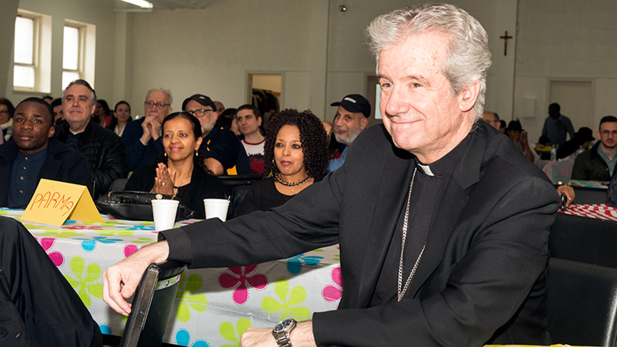 Archbishop Lépine listening to the refugees sponsored by the diocese, on April 6, 2019.