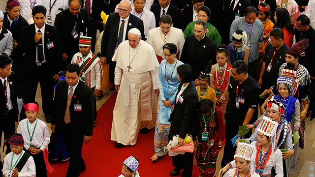 Pope Francis greets children as he arrives at Yangon International Airport in Yangon, Myanmar, Nov. 27. The pope is making a six-day visit to Myanmar and Bangladesh