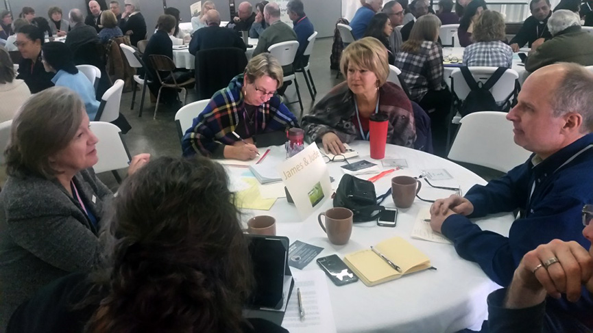 St. Luke parishioners L. Cormier (left), A. Rozenstraten discuss parish renewal, next steps at Jan. 26 follow-up.