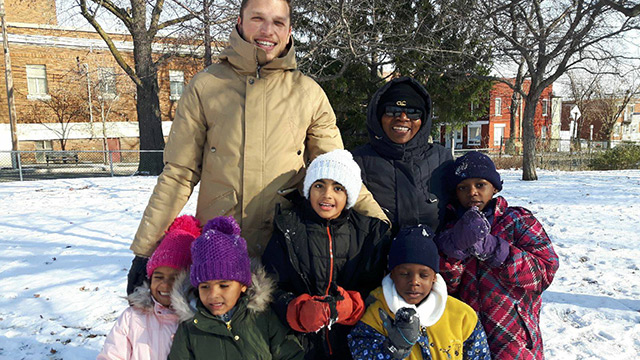 Co-ordinator Arthur Durieux with children of families seeking asylum, outside Le Pont.