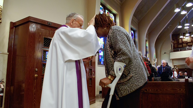 A priest performing perform the sacrament of the Anointing of the Sick