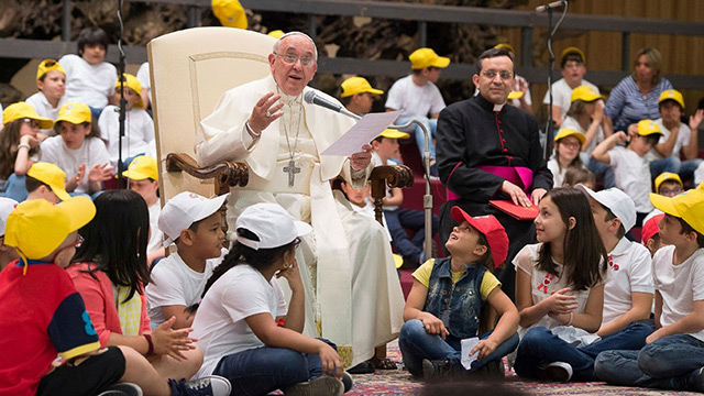 Pope Francis surrounded by kids