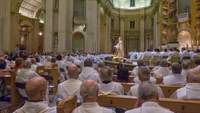 Archbishop Lépine with fellow priests surrounding him during Chrism Mass.