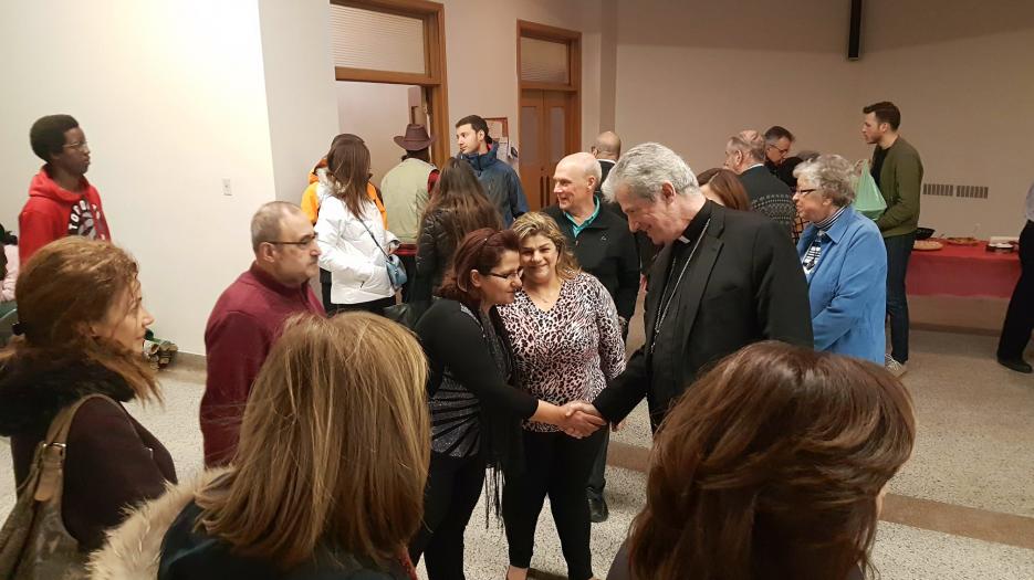 Msgr. Lépine welcoming one refugee family from Syria.