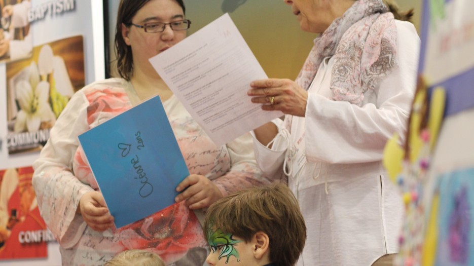 Christiane giving to parents a list of parish supporting the faith awakening and "Little Heart Playgroup" (Photo: Isabelle de Chateauvieux)