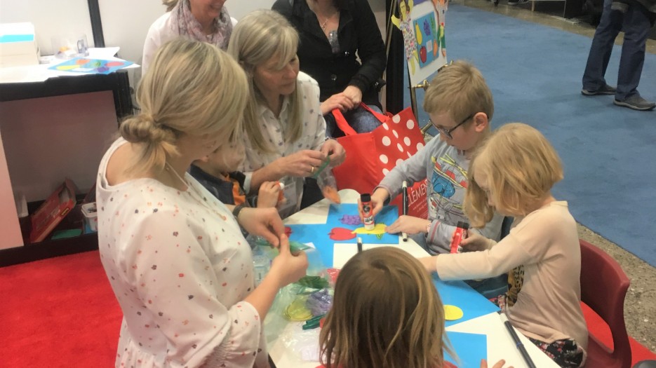 Michelle Cooper surrounded by the many children and their parents (Photo: Isabelle de Chateauvieux)