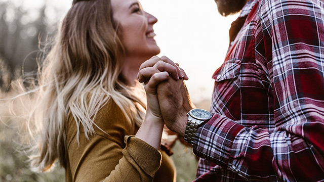 A loving couple holding hands.